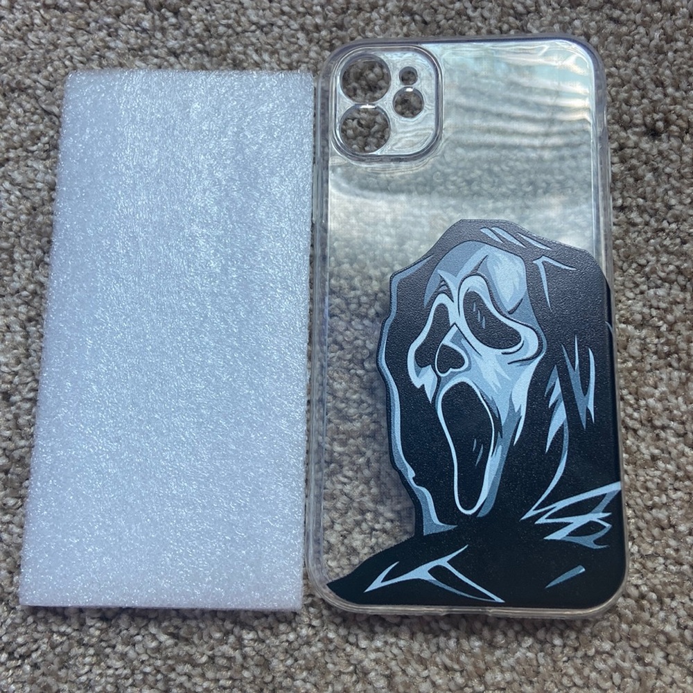 iPhone case with ghost face on it or (scream) and it’s transparent phone case.